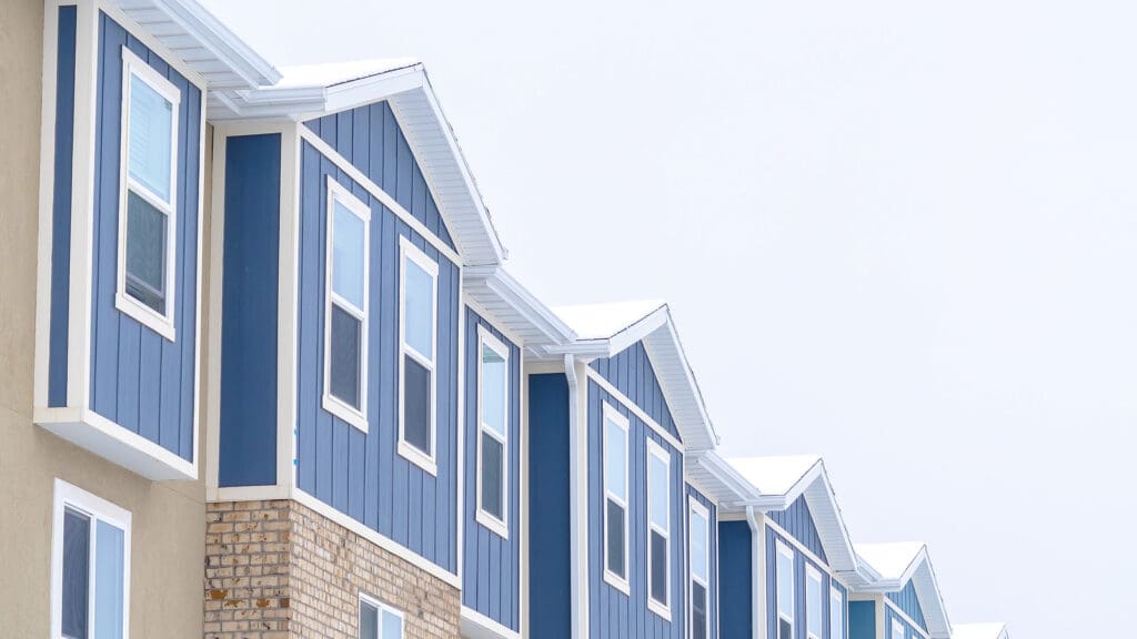 a row of windows with vertical siding